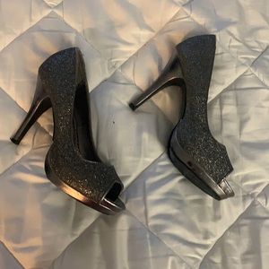 3 1/2 inch silver/ black heels , well worn